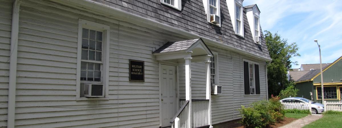 Two story white house with dormer windows