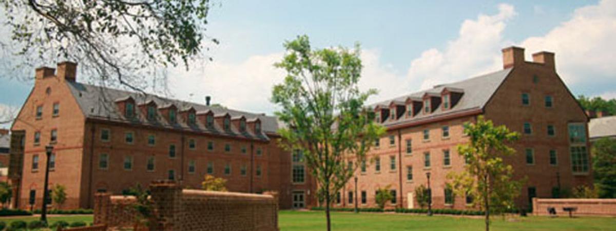 Jamestown Residence, a four story, brick L-shaped building with large field in front