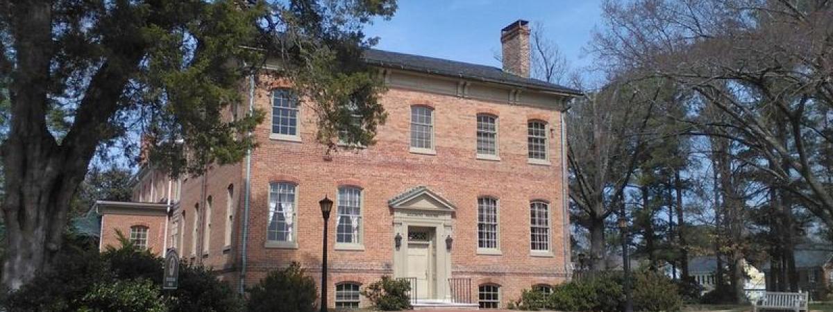 Two story colonial brick building with circular driveway