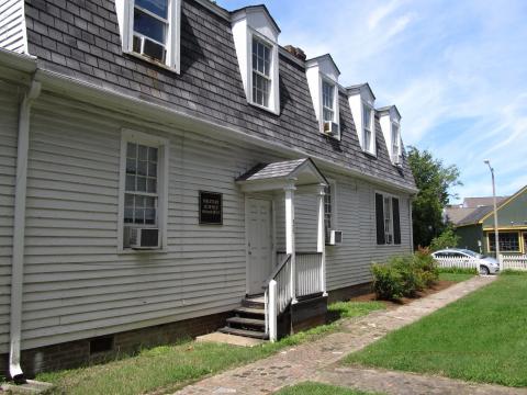 Two story white house with dormer windows