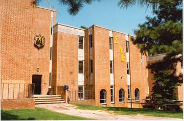 Three story modern brick building with thin columns of windows