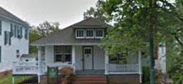 Single story bungalow style house with white siding and covered front porch