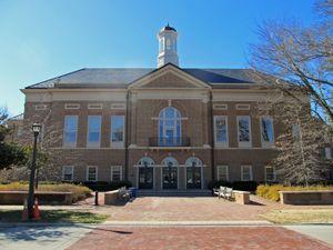 Front of the two story brick Mason School of Business