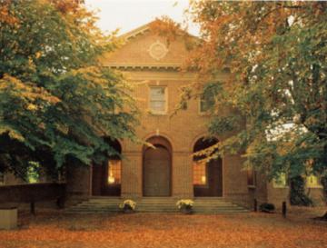 Front entrance of Ewell Hall surrounded by trees in fall color