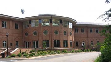 Three story brick and glass Football Center with central round room