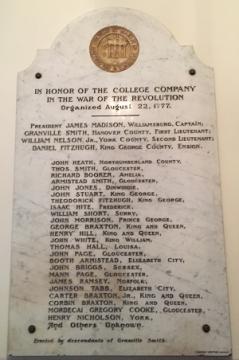 Gray and white marble plaque with the engraved names of the College Company