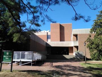 Front entrance to Millington Hall with covered entrance and modern architecture of brick and concrete